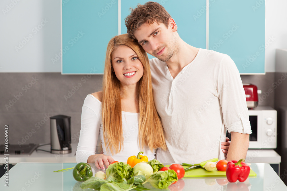 Young beautiful couple cooking at home