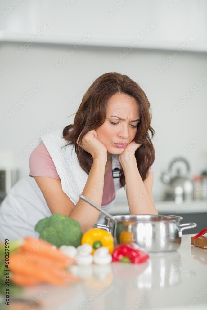 Serious woman preparing food in kitchen Serious woman preparing food in kitchen