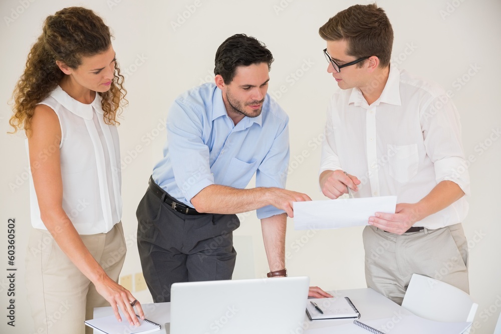 Business people discussing over document Business people discussing over document