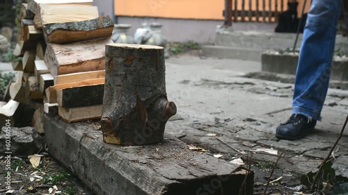 Wallpaper Mural Lumber jack man chopping wood logs with ax. Making firewood Torontodigital.ca