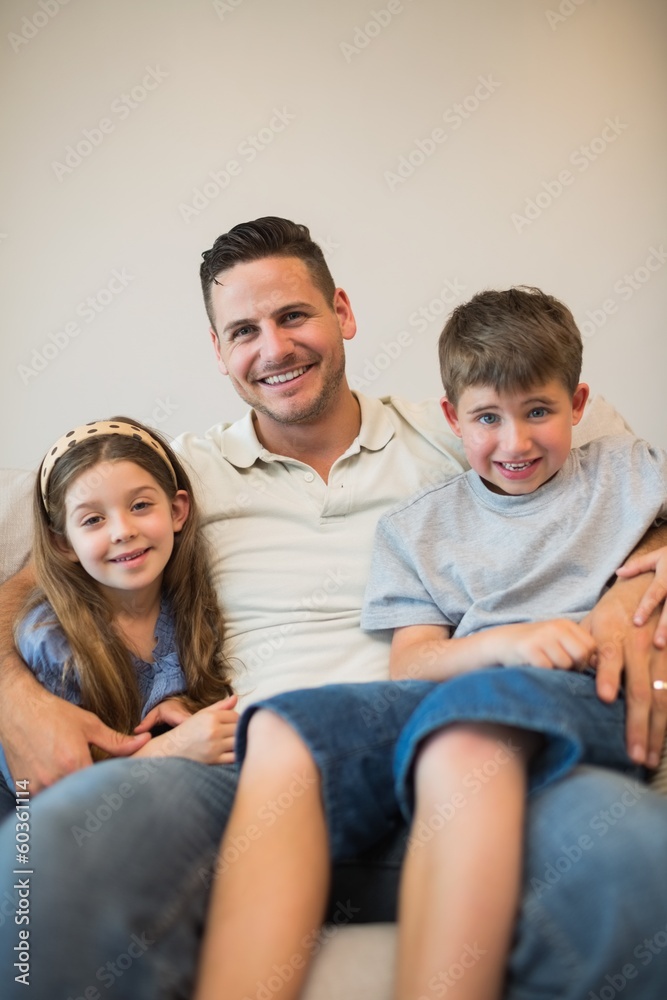 Father with son and daughter smiling on sofa Father with son and daughter smiling on sofa