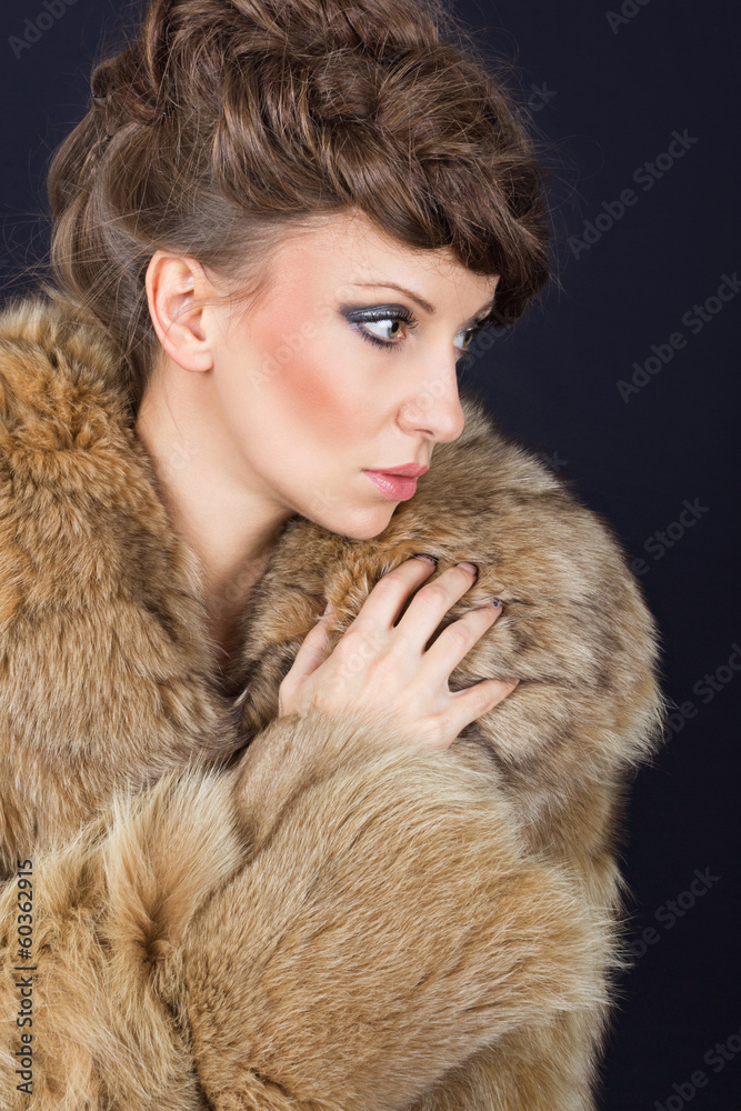 Sensual brunette woman wearing brown fur coat
