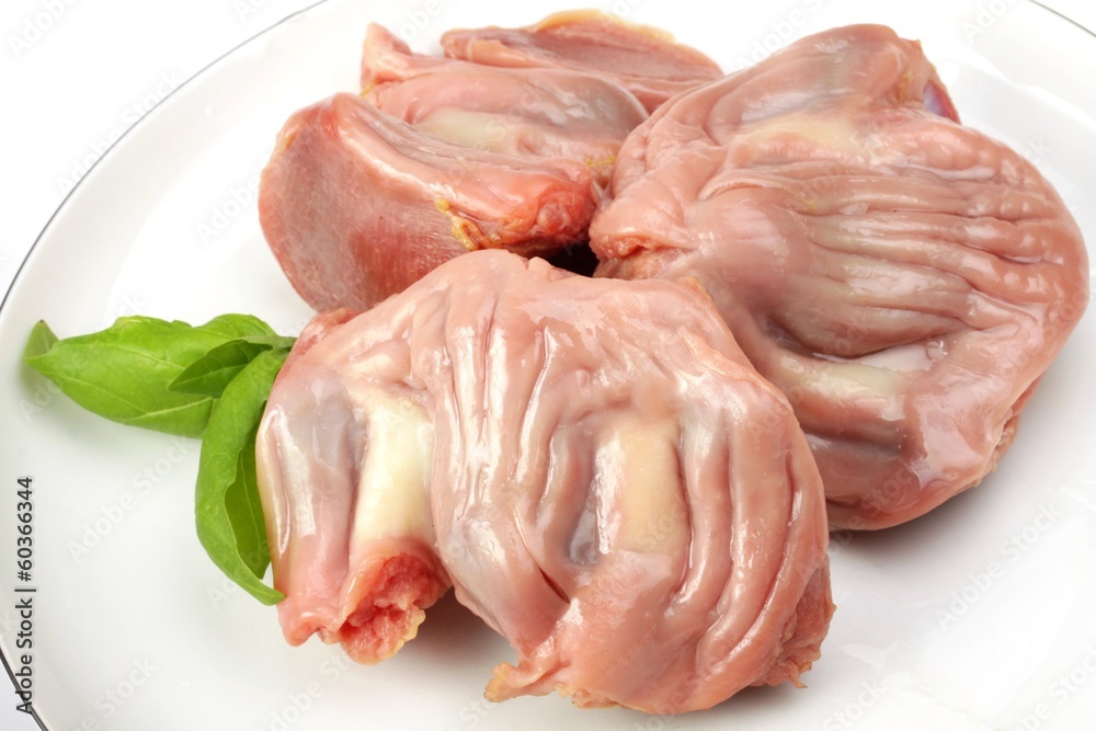 raw stomachs with turkey on a wooden board raw stomachs with turkey on a wooden board