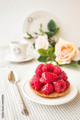 Tartlet with fresh raspberries, selective focus
