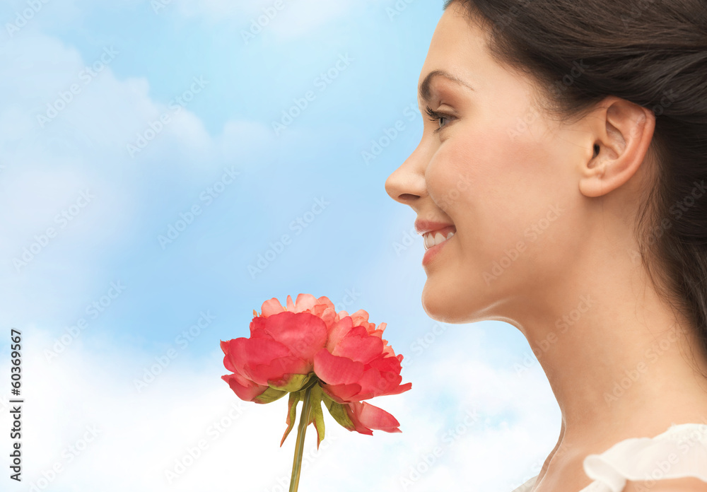 smiling woman smelling flower smiling woman smelling flower