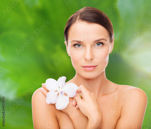 relaxed woman with orchid flower