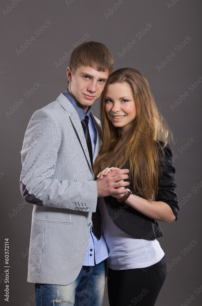 Beautiful young smiling couple in love embracing indoor Beautiful young smiling couple in love embracing indoor