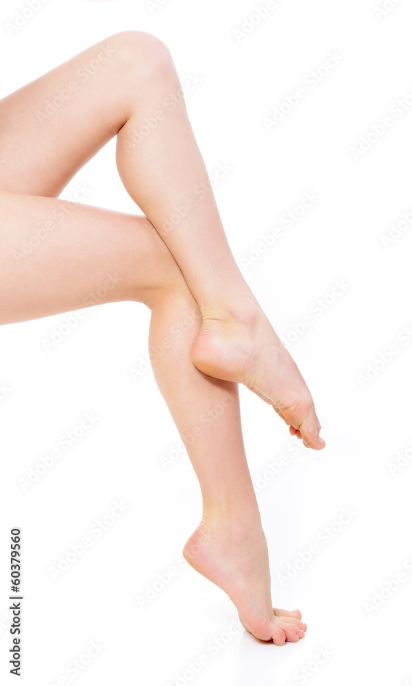 beautiful graceful female legs of young woman over white