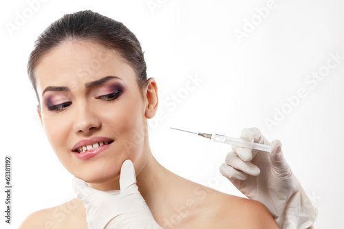 emotional young woman afraids of syringe  beauty treatment theme