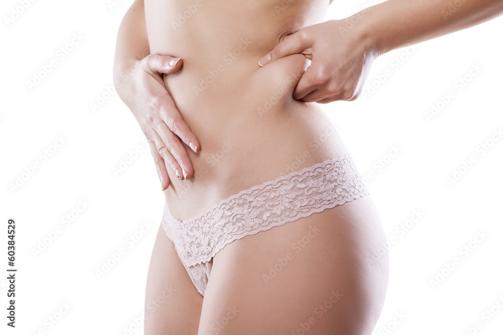 young woman pinches her waist for test young woman pinches her waist for test