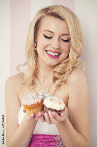 Happy elegant woman with muffins