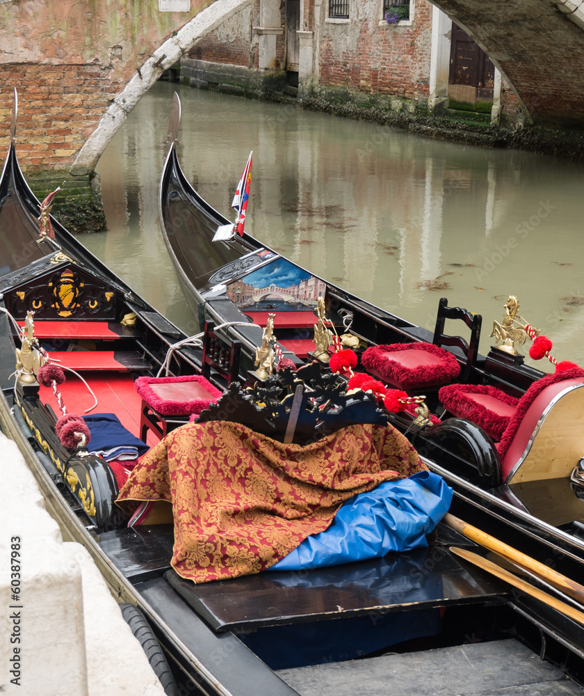 Two gondolas moored along a canal  in Venice