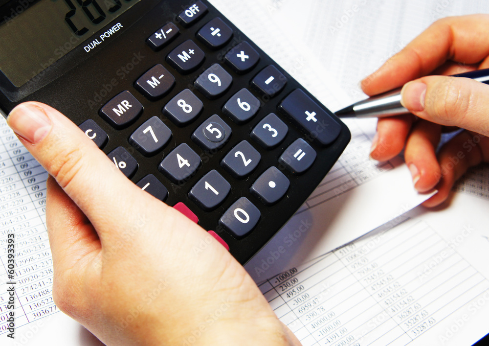 Office table with calculator, pen and accounting document