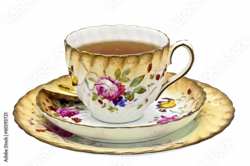 Tea in an antique china cup with saucer and dessert plate.
