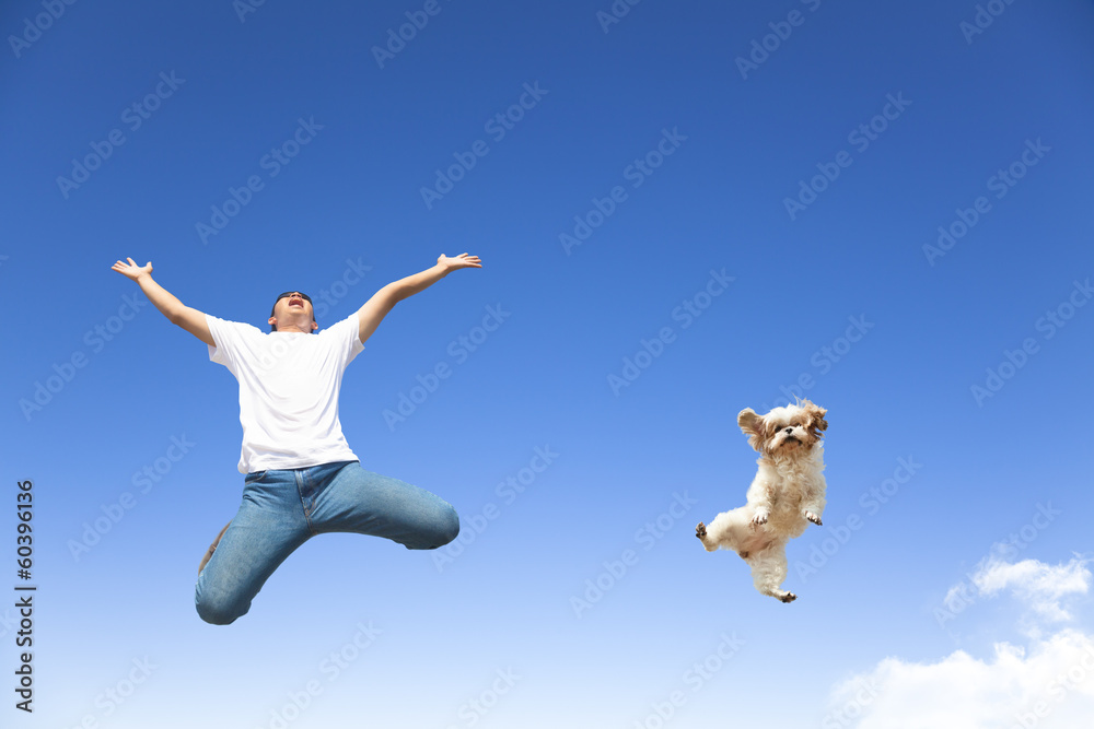 young man and dog jumping in the sky young man and dog jumping in the sky