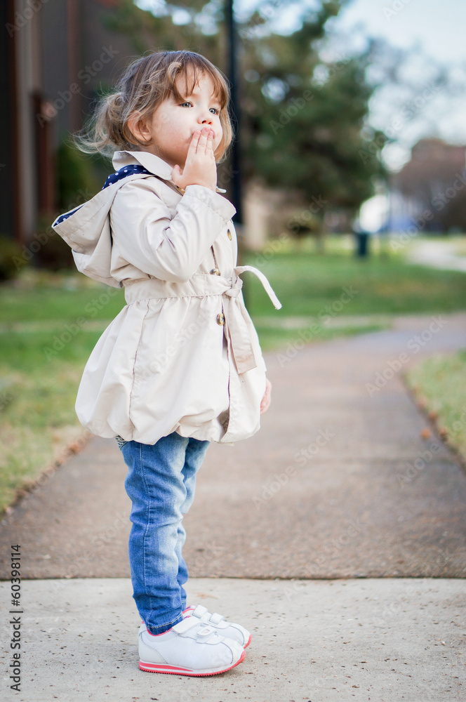 Fototapeta premium Cute fashionable baby girl smiling outdoors