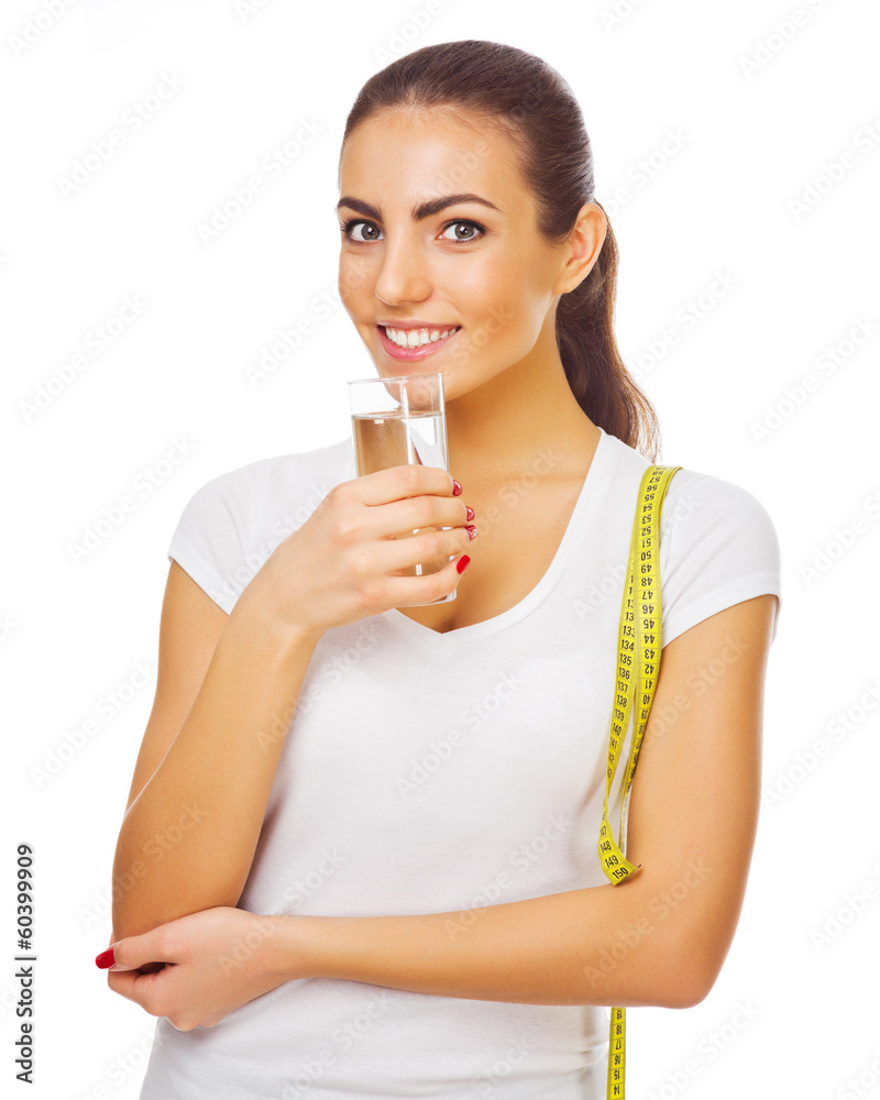 Young sporty girl with measurement tape and water glass Young sporty girl with measurement tape and water glass