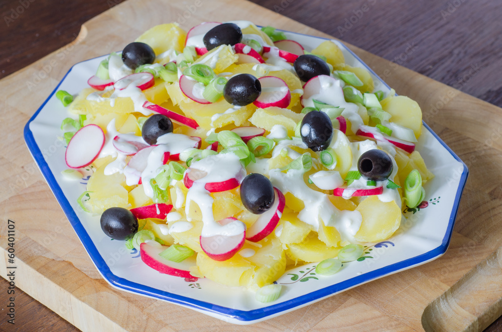 Potato and yogurt salad with black olives and radish