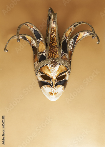Venetian carnival mask on golden surface