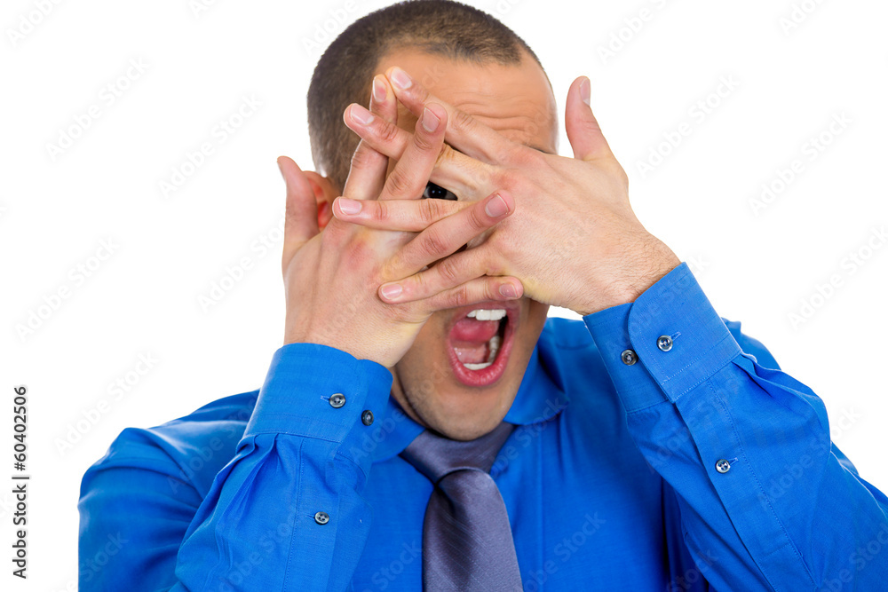 Headshot young shy timid man covering face with hands Headshot young shy timid man covering face with hands