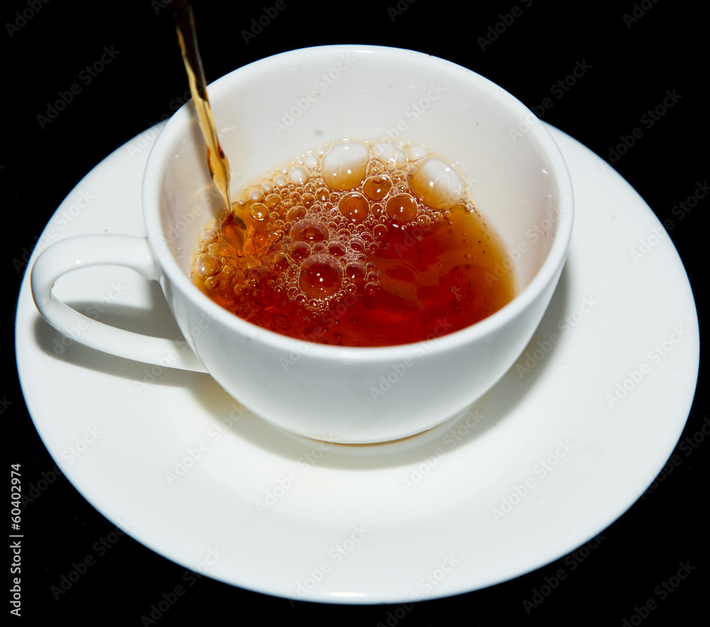 tea in a cup on a black background