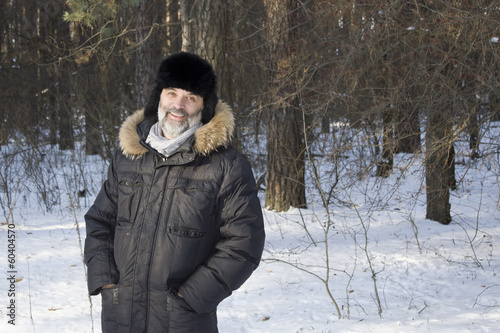 Portrait of middle-aged man in the winter forest