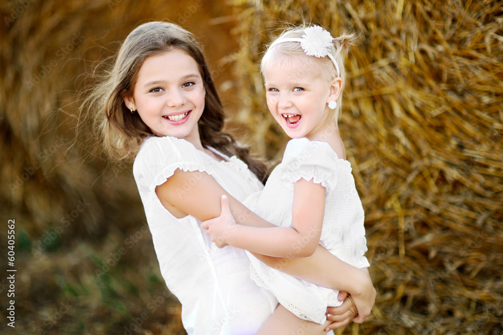 Portrait of two happy sisters in nature Portrait of two happy sisters in nature