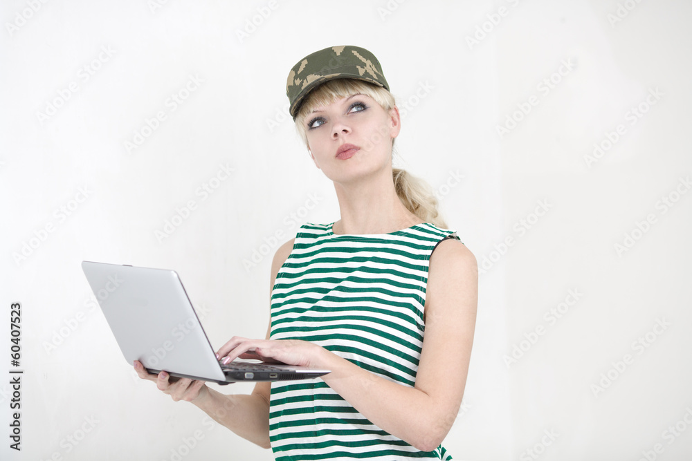 Girl in army cap with laptop Girl in army cap with laptop