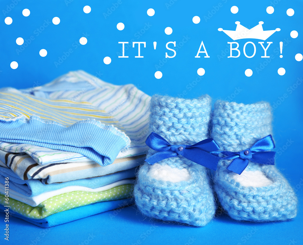Pile of baby clothes on blue background