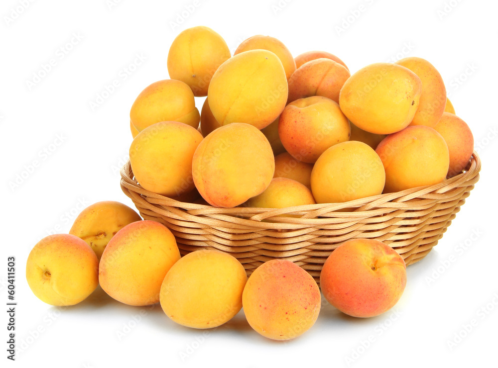 Fresh natural apricot in wicker basket isolated on white Fresh natural apricot in wicker basket isolated on white