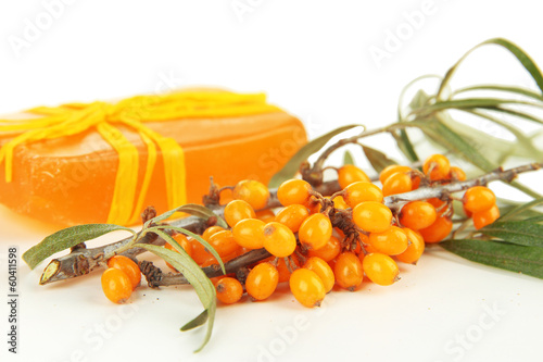 Branches of sea buckthorn with soap isolated on white photo