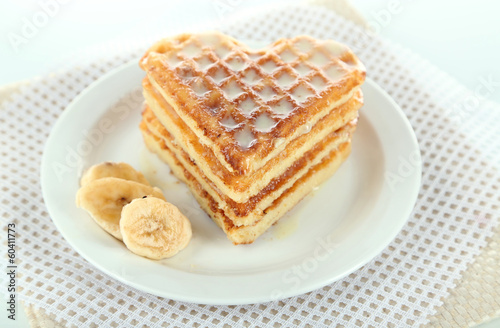 Sweet Belgium waffles with banana, isolated on white