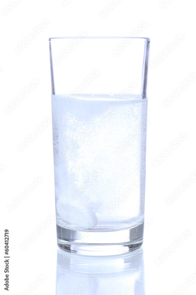 Glass with efervescent tablet in water with bubbles isolated Glass with efervescent tablet in water with bubbles isolated