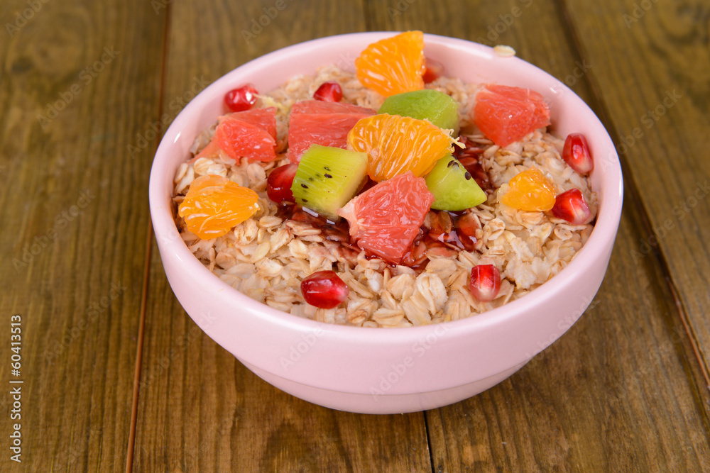 Delicious oatmeal with fruit in bowl on table close-up Delicious oatmeal with fruit in bowl on table close-up
