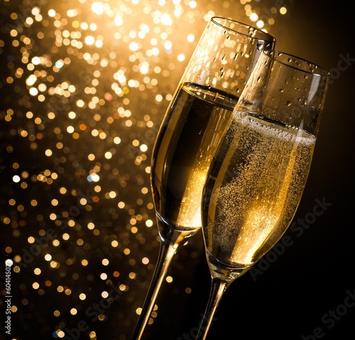 champagne flutes on dark golden bokeh background