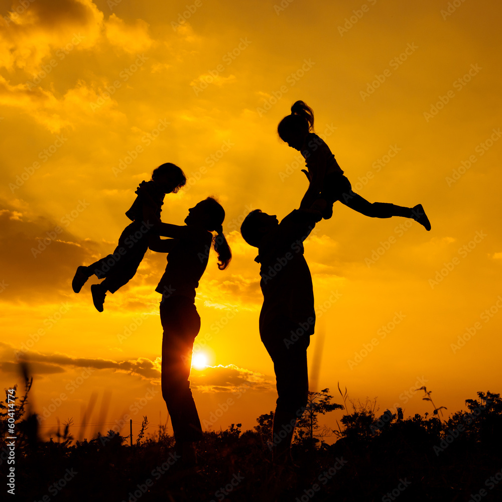Happy  family playing on the  road in the  sunset time. Evening