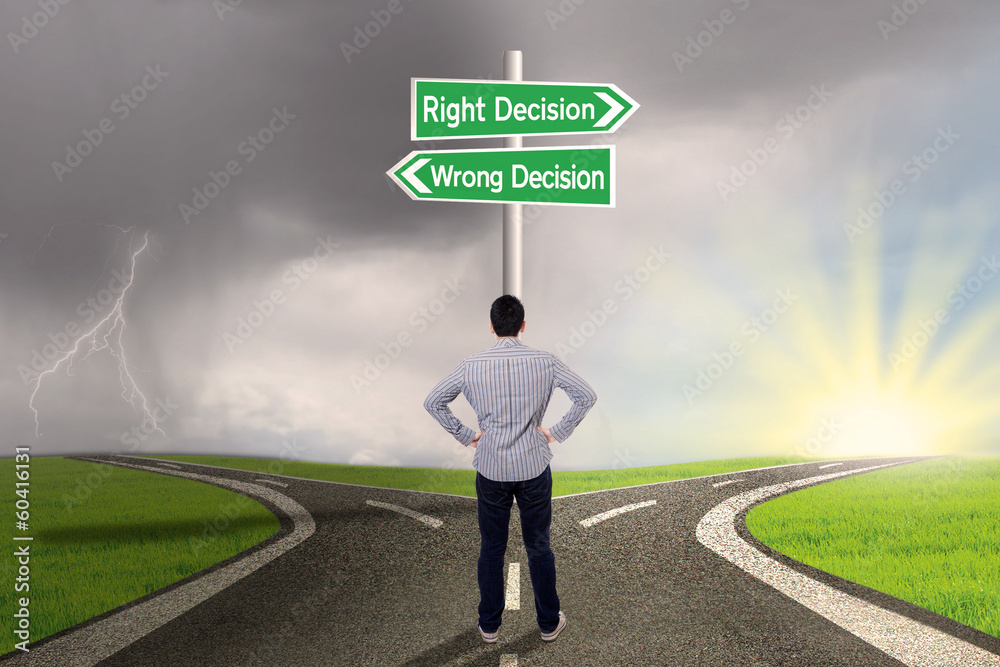 Businessman with a sign of right vs wrong decision Businessman with a sign of right vs wrong decision