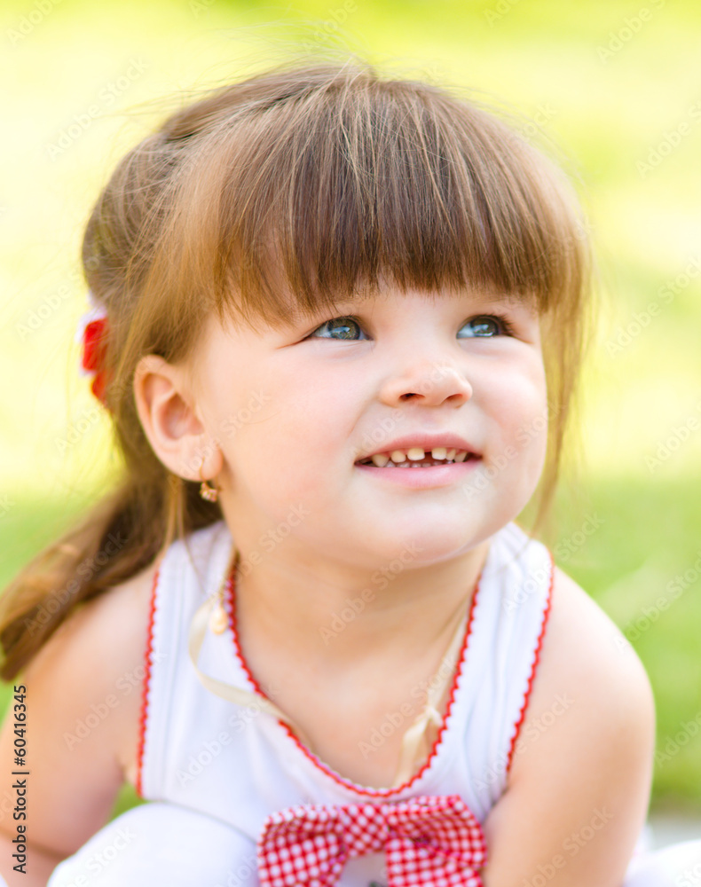 Young girl is playing outdoors Young girl is playing outdoors