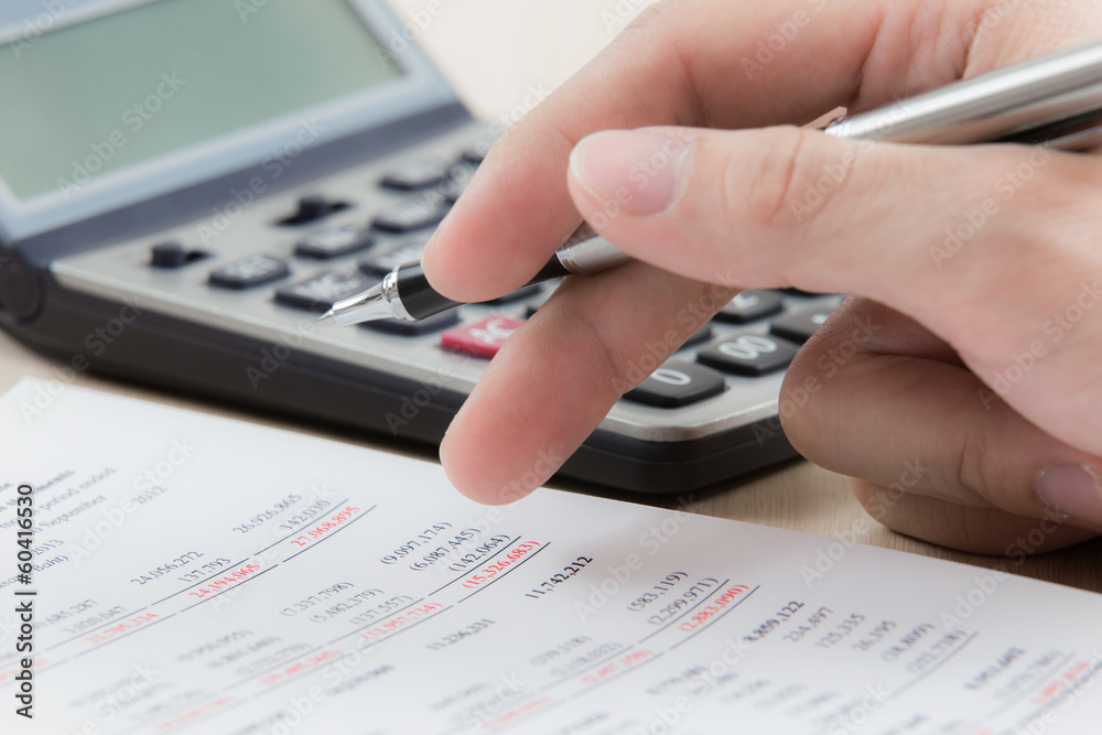 Finger is pressing calculator button Finger is pressing calculator button
