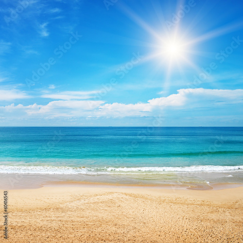 seascape and sun on blue sky background
