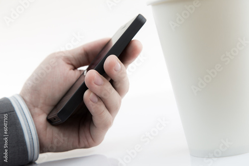 Businessman Using Cell Phone with coffee cup