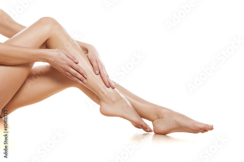woman apply cream on her bare feet