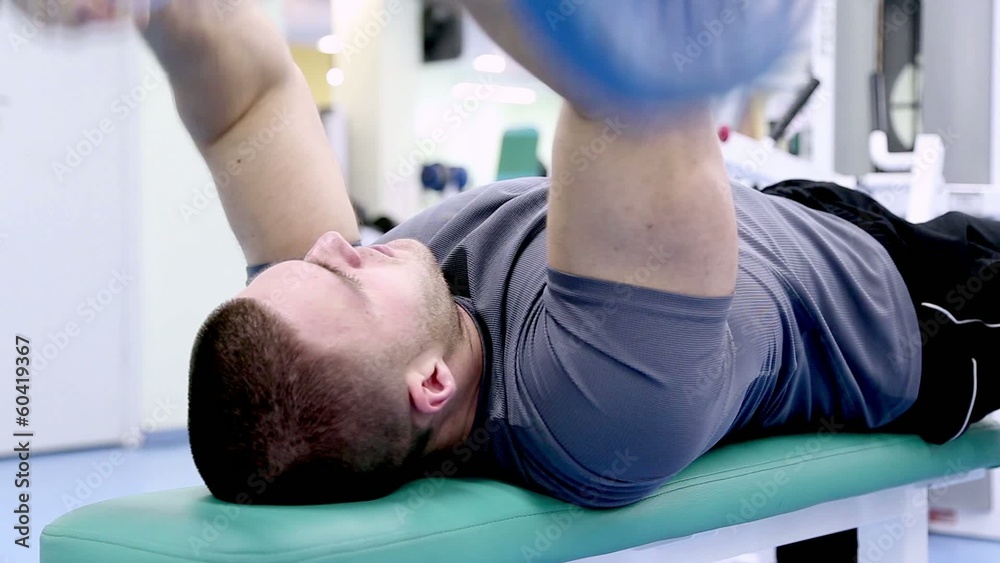 man at the gym, training triceps hands with a barbell man at the gym, training triceps hands with a barbell