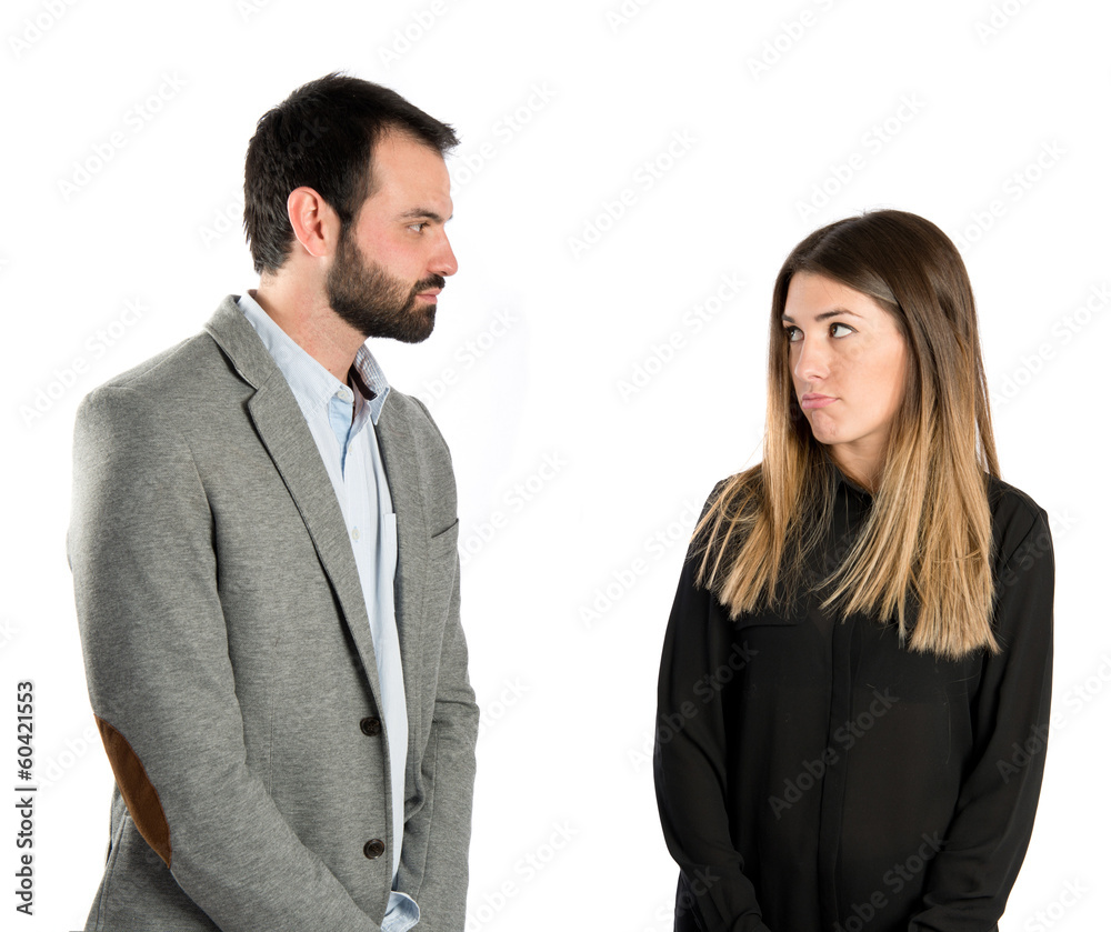 Young couple doing a joke over isolated white background Young couple doing a joke over isolated white background