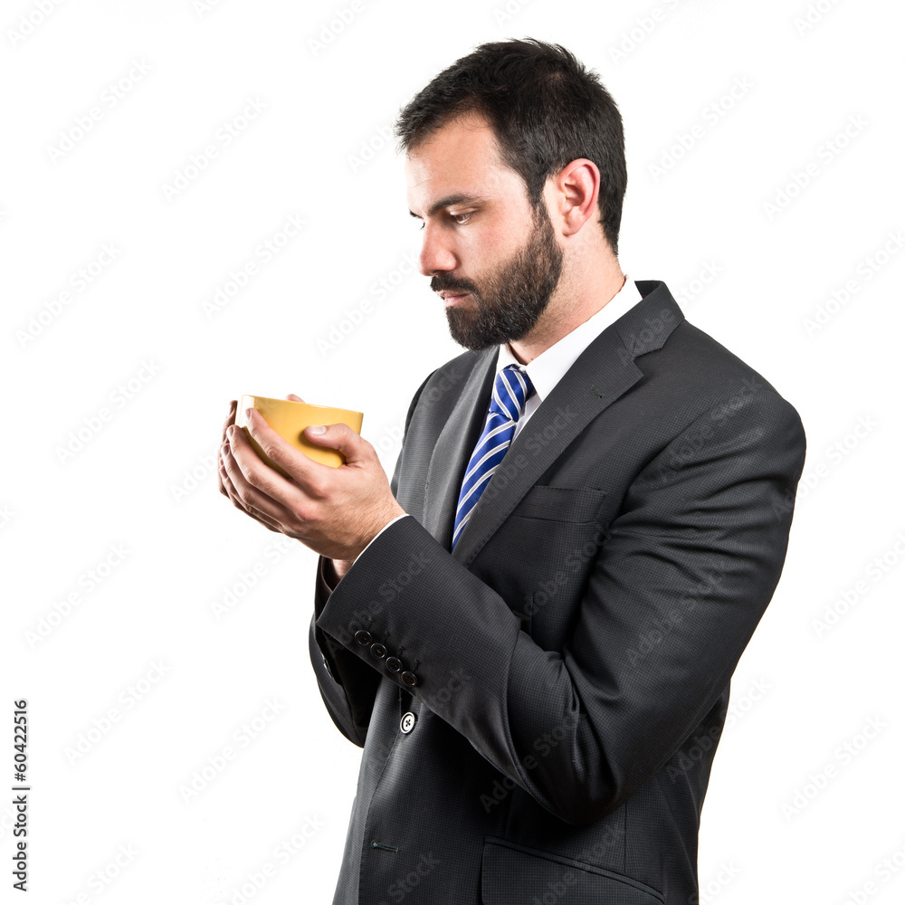 Young businessman drinking a coffee over white background Young businessman drinking a coffee over white background