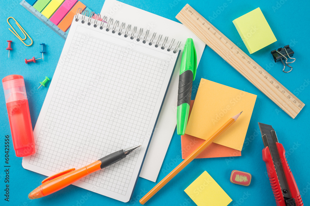 School office supplies on blue background