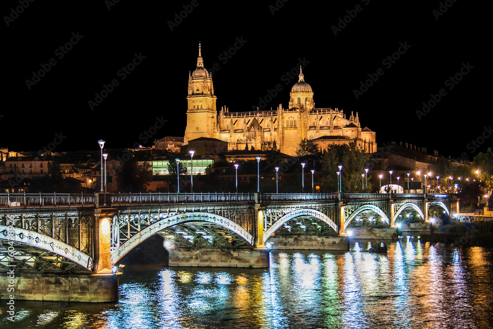 Historic city of Salamanca with river Tormes at night, Spain