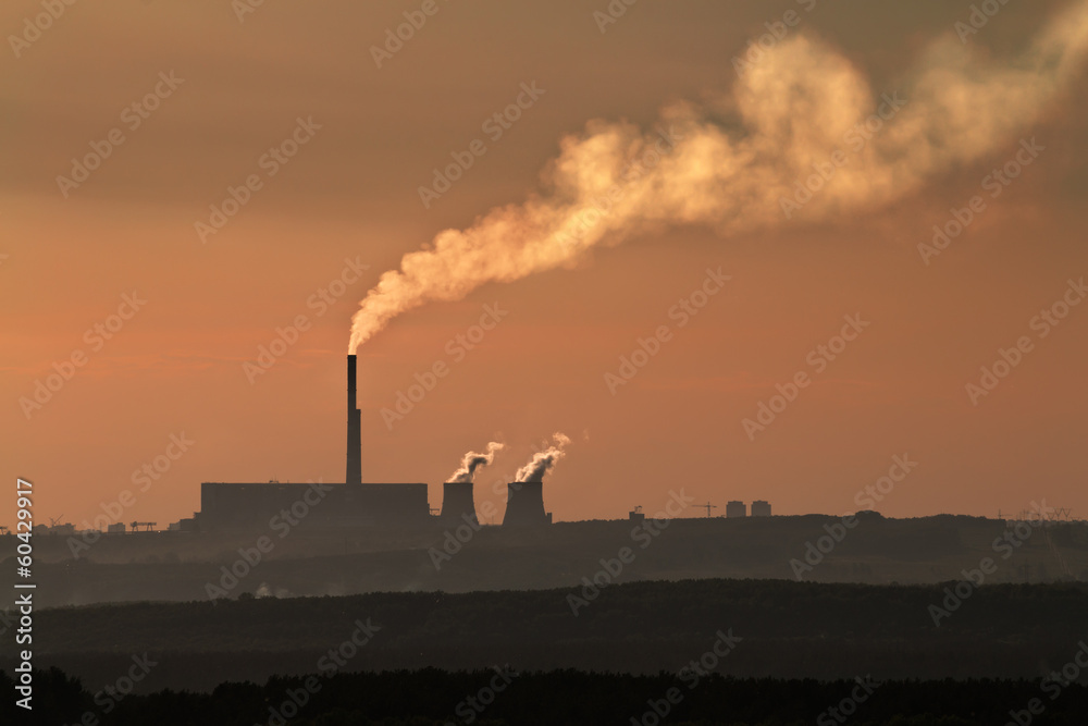 The silhouette of coal plant with thick smog