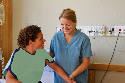 Nurse helping patient stand up