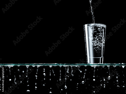 Pouring water into metal bottle photo